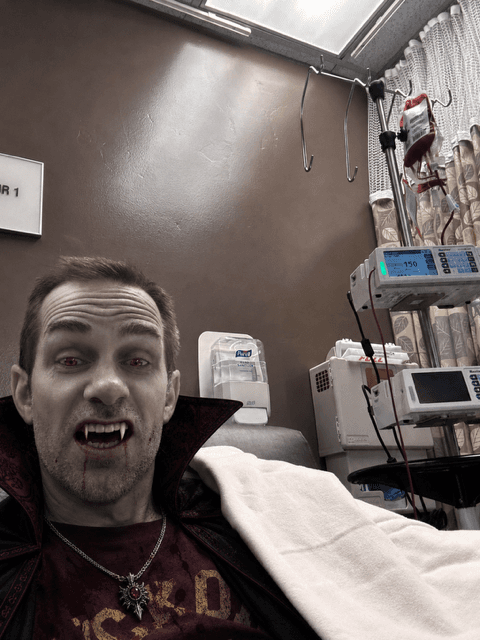 Nathan at a previous blood transfusion being a clown or I guess a vampire.